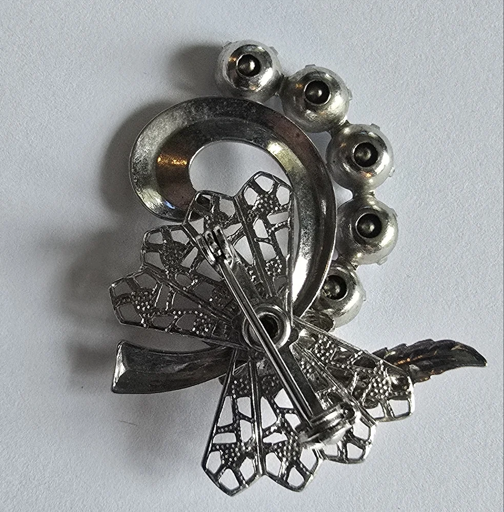 Vintage brooch pin pale blue rhinestones swirl filigree